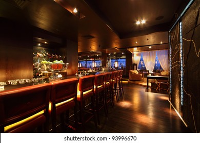 bar counter with chairs in empty comfortable restaurant at night