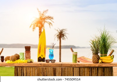 Bar counter on the beach at Hawaii. Glasses with cocktails, coconut, sun glasses lie on the table. Concept of relaxing, preparation and summer - Powered by Shutterstock