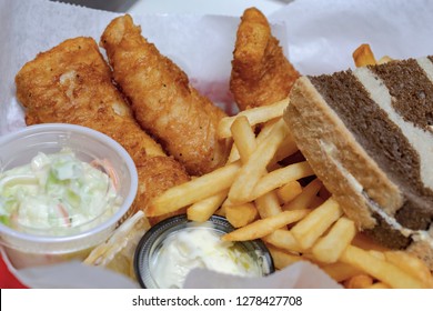 Bar Food:  Typical Friday Night Fish Fry In Wisconsin.  Fried Cod, French Fries, Coleslaw, Tartar Sauce And Marbled Rye Bread In A Basket.