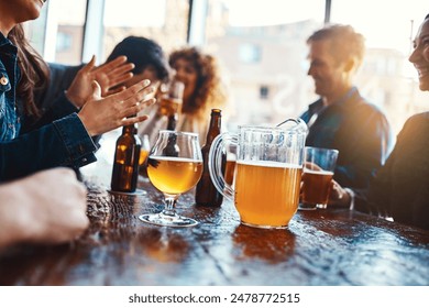 Bar, group and hands for beer, fun and party for joy, reunion and celebration for friends and event. Table, alcohol and drinks to enjoy, glass and people in club, break and together in Los Angeles - Powered by Shutterstock