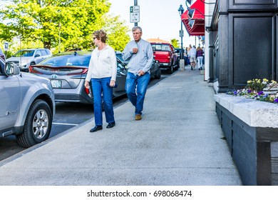 Bar Harbor, USA - June 8, 2017: Older Couple Walking On Sidewalk During Sunset In Downtown Village In Summer