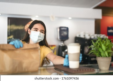 Bar Owner Working Only With Take Away Orders During Corona Virus Outbreak - Young Woman Worker Wearing Face Surgical Mask Giving Meal To Customers - Healthcare And Food Drink Concept 