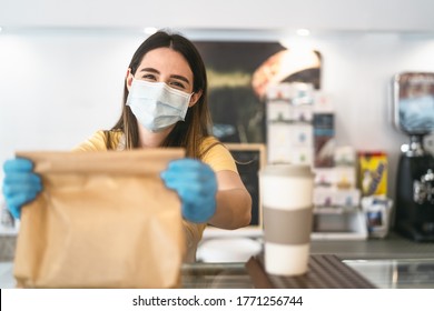 Bar Owner Working Only With Take Away Orders During Corona Virus Outbreak - Young Woman Worker Wearing Face Surgical Mask Giving Takeout Meal To Customers - Healthcare And Food Drink Concept 