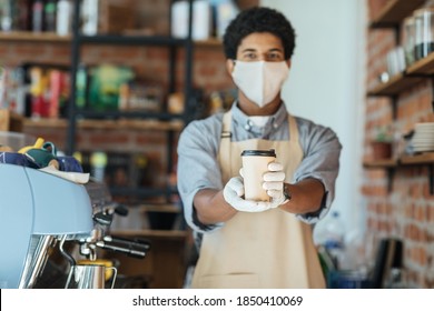 Bar Owner Works Only With Take Away Orders During Corona Virus Outbreak, Healthcare And Food Drink Concept. Young Man Worker In Face Protective Mask Giving Takeout Espresso To Clients In Cafe