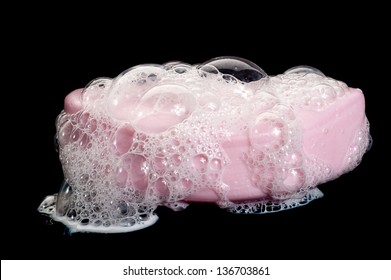 A Bar Of Soap With Soap Bubbles On Black Background