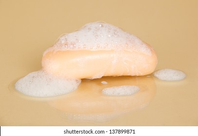 Bar Of Soap With Suds On A Beige Background  