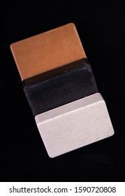 Bar Soaps Of Brown, Black, White Color Laying On A Black Background. Spa Concept. Eco-friendly. Delicate Soap Cleanser For Face And Body. 