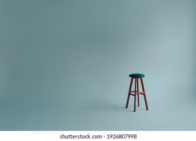 Bar Stool With Upholstered Backless Seat In An Empty White Room On A Gray Background.