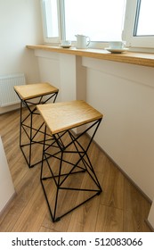 bar stools by the window with a bar