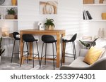 Bar stools near table in room. Interior design