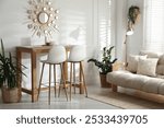 Bar stools near wooden table in room