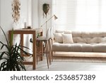 Bar stools near wooden table in room