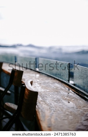 Bar table placed on the restaurant's balcony terrace looked wet because of the rain