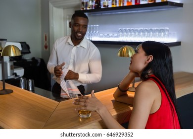 Bar Tender Talking With Beautiful Woman At Counter