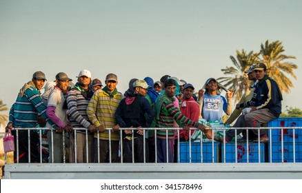 BARBAR, BAHRAIN - NOVEMBER 15: Migrant Fisherman From India Wait To Be Transported To Their Housing From Their Boats On The Back Of A Truck At Dawn.