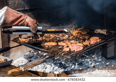 Similar – Man cooking on a barbecue