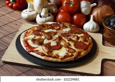 Barbecue Or BBQ Meat Feast Pizza With A Topping Of Pepperoni, Sausage, Salami And Chicken Wings