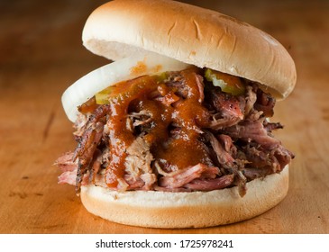 Barbecue beef brisket Sandwiches. BBQ Traditional Texas barbecue sandwiches. Pulled pork. Thick sliced smoked beef brisket. Chopped beef brisket with barbecue sauce bbq sauce. Served on white buns.