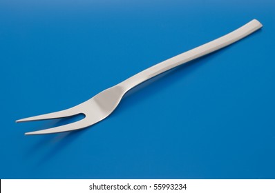 Barbecue Carving Fork Isolated On The Blue Background.