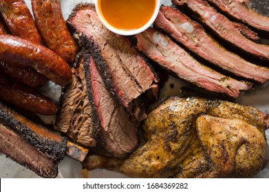 Barbecue Catering Platter With Variety Of Meats. Traditional Texas BBQ: Beef Brisket, Beef Ribs, Pork Ribs, Sausage Links, Black Pepper Roasted Chicken, And Turkey Served With Homemade Sauce.