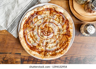 Barbecue Chicken Pizza With Sauce, Mozzarella Cheese, Fresh Red Onions And A Sauce Swirl Served In A Portland, Oregon Restaurant.