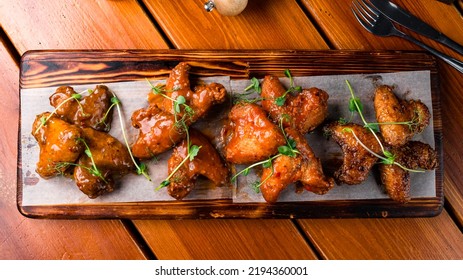 Barbecue Chicken Wings Close Up On Wooden Tray