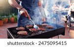 Barbecue, cooking and man with burgers outdoor backyard for meal at reunion, social event or lunch on terrace. Party, food and male person grilling patty, beef or meat for bbq dish on weekend at home