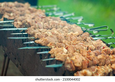 Barbecue cooking on the grill, the meat on the skewers is stacked in a row