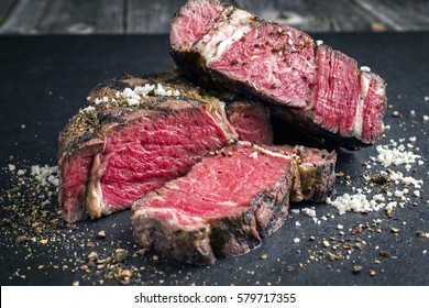 Barbecue Dry Aged Kobe Rib Eye Steak As Close-up On A Black Slate