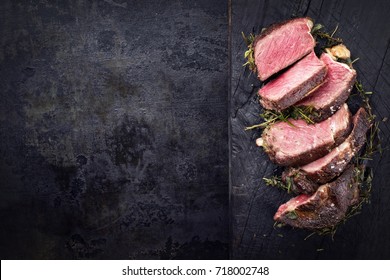 Barbecue dry aged Kobe rib eye steak as close-up on a burnt board with copy space left  - Shutterstock ID 718002748