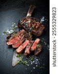 Barbecue Dry aged raw beef steaks - entrecote cuts medium roasted with herbs and salt