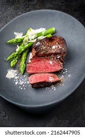 Barbecue Dry Aged Wagyu Sirloin Beef Steak Sliced Green Asparagus And Parmesan Cheese As Top View On A Gray Cast Iron Design Plate 