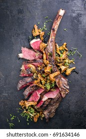 Barbecue dry aged wagyu tomahawk steak sliced with as close-up on old wooden board