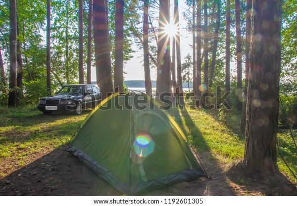 Barbecue family. Concept of outdoor recreation by\
the family. On a background blurred car. camping. picnic in the\
forest