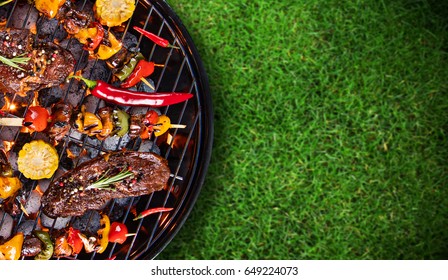 Barbecue garden grill with beef steaks, close-up.