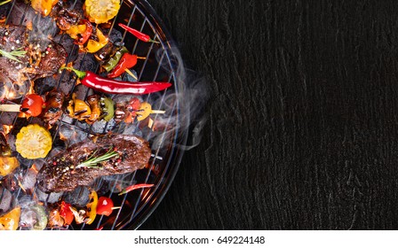 Barbecue garden grill with beef steaks, close-up.