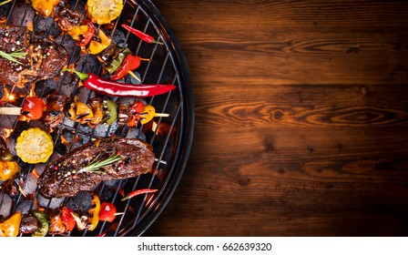 Barbecue garden grill with beef steaks, close-up. - Shutterstock ID 662639320
