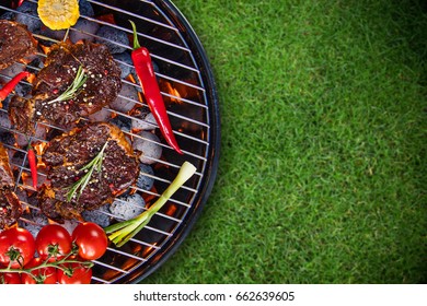 Barbecue garden grill with beef steaks, close-up. - Shutterstock ID 662639605