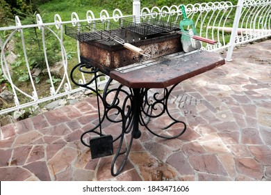 Barbecue Grill In The Backyard Outside. Empty Dirty Kitchen Equipment After Cooking Dinner. Black Grill With Charcoal. No Bbq Celebration During Pandemic. Unhealthy Lifestyle For Non-vegan People.