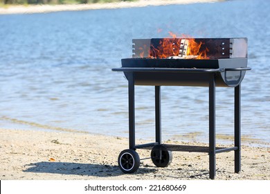 Barbecue grill on beach of river - Powered by Shutterstock