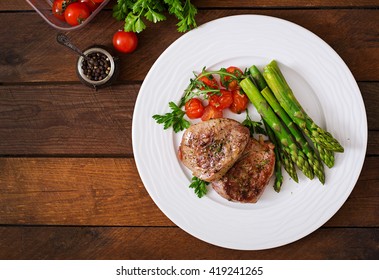 Barbecue Grilled Beef Steak Meat With Asparagus And Tomatoes. Top View