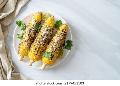 Barbecue And Grilled Corn With Cheese And Lime On Plate