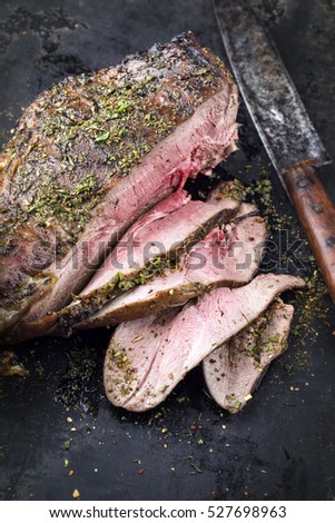 Barbecue Haunch of Venison on old Metal Sheet