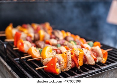 Barbecue Kabobs Smoking On The Grill. Smoked Meat And Vegetables. Grilling Kebabs On The Barbeque. Selective Focus With Copy Space.