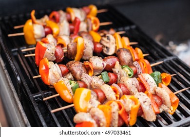 Barbecue Kabobs Smoking On The Grill. Smoked Meat And Vegetables. Grilling Kebabs On The Barbeque. Selective Focus With Copy Space.