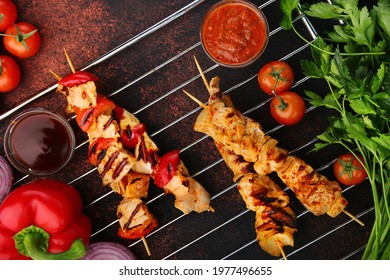 Barbecue On Skewer With Sauce And Vegetables On Table Top View. Bbq Concept.