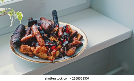 Barbecue Party Leftovers Grilled And Burnt Sausages Skewers And Meat