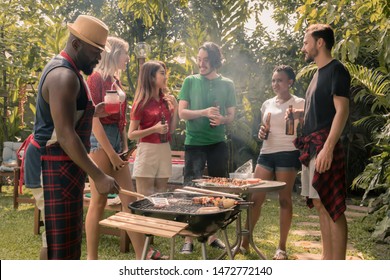 barbecue and party.Happy friends with barbecue party in nature