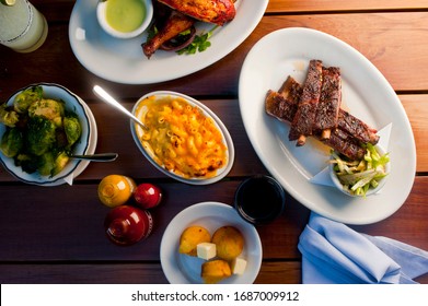 Barbecue. Picnic BBQ Table Spread. Beef Brisket, Chicken, Pork Ribs, Beef Ribs, Mac N Cheese, Cornbread, Brussels Sprouts, Coleslaw, And Beer. Classic Traditional Texas Bbq Meats And Side Dishes.