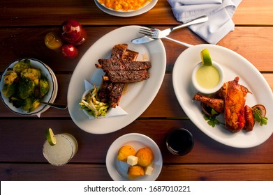 Barbecue. Picnic BBQ Table Spread. Beef Brisket, Chicken, Pork Ribs, Beef Ribs, Mac N Cheese, Cornbread, Brussels Sprouts, Coleslaw, And Beer. Classic Traditional Texas Bbq Meats And Side Dishes.